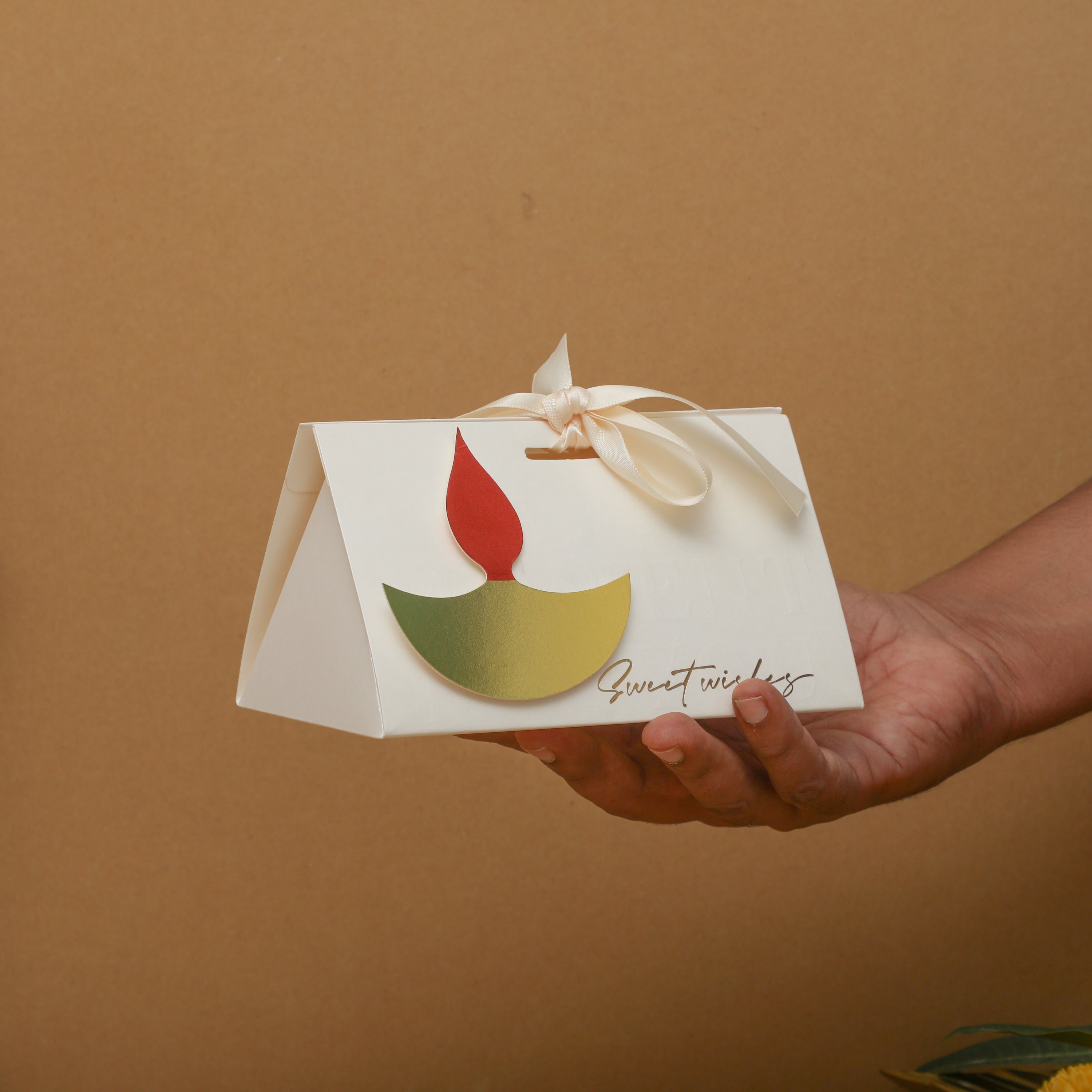 Demonstrating the box dimensions by holding it in hand