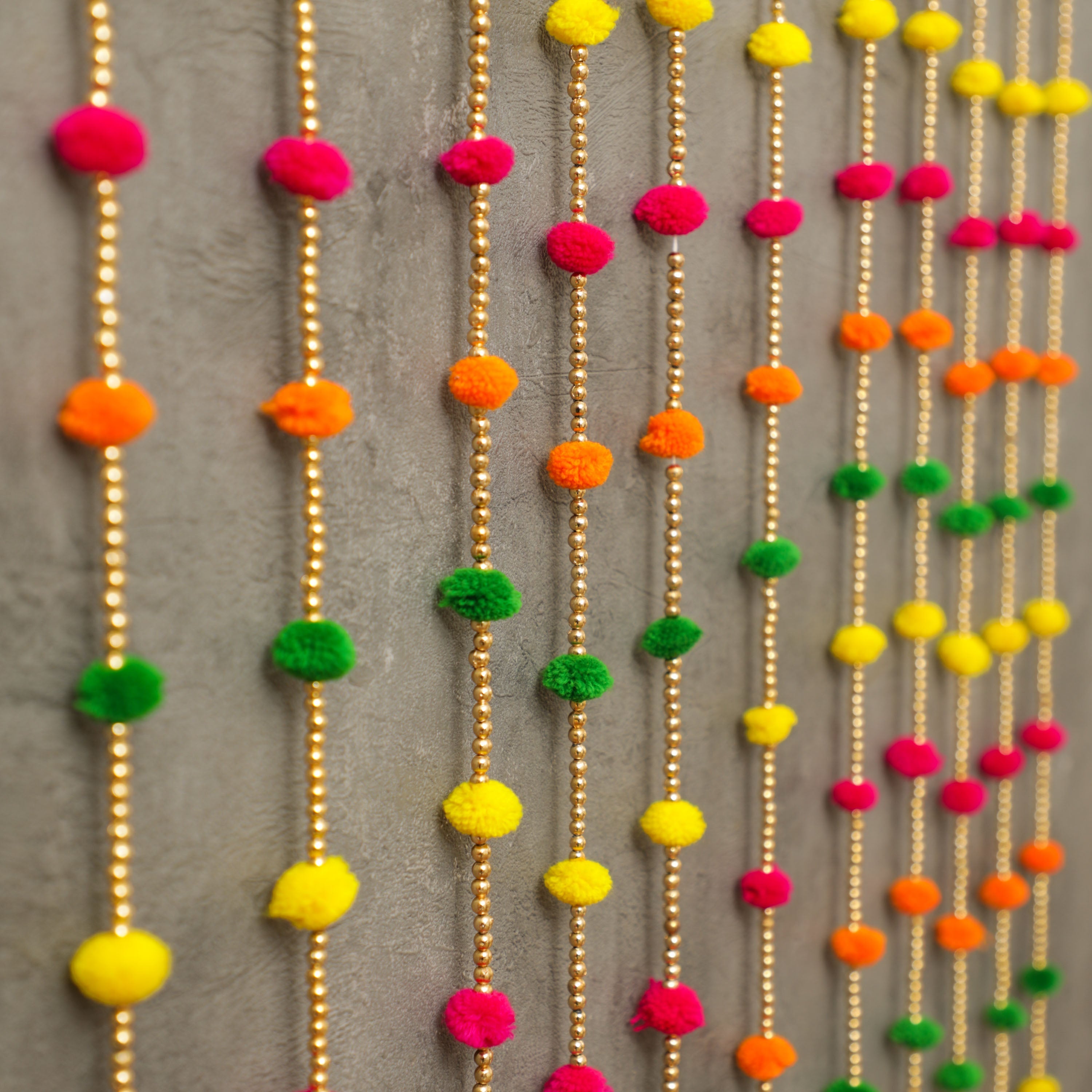 The multicolor design makes it easy to match with any decor or color scheme, and the playful pom-poms and bells add a fun and festive touch to any space.