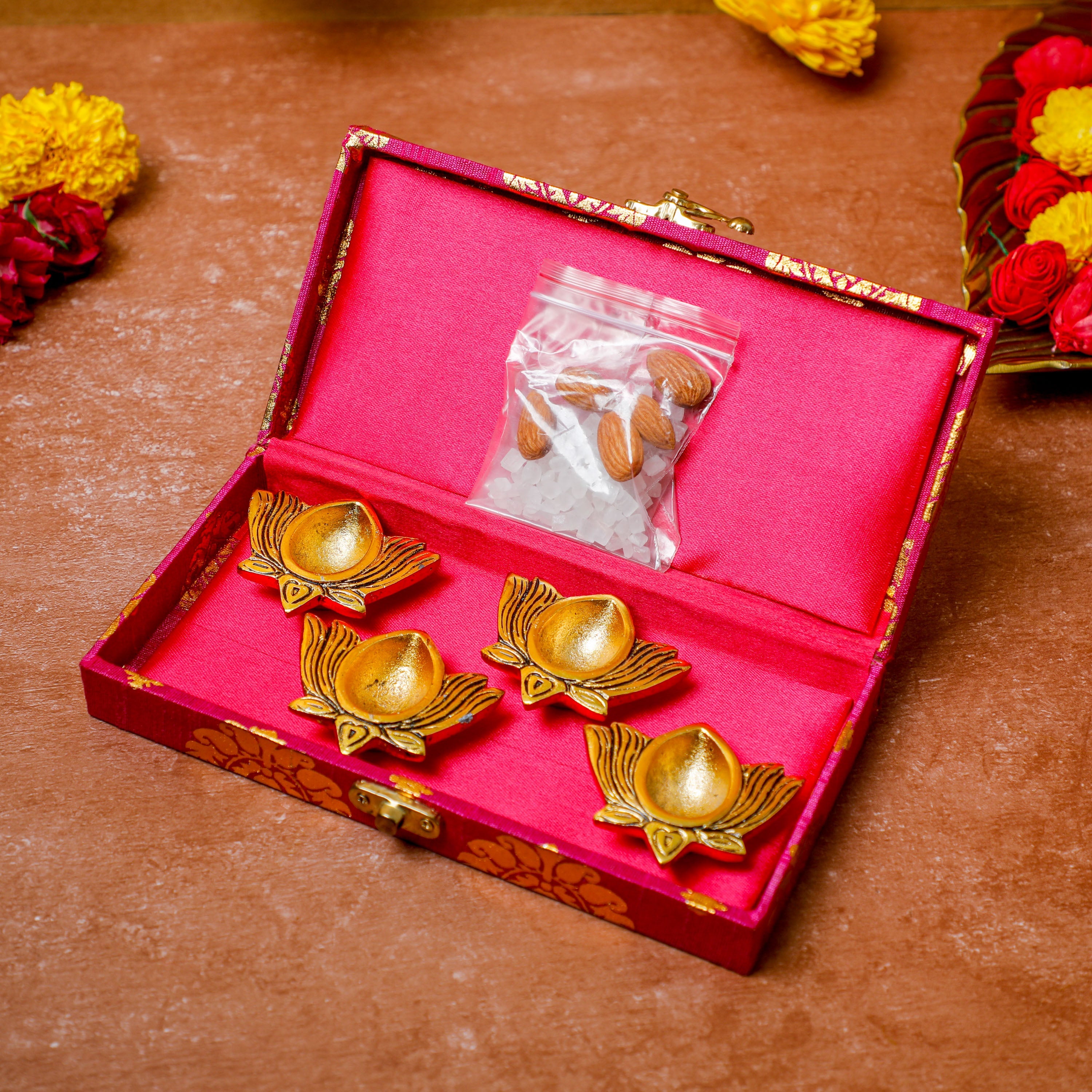 Our Gift hamper consist of 4 diyas & sweetner