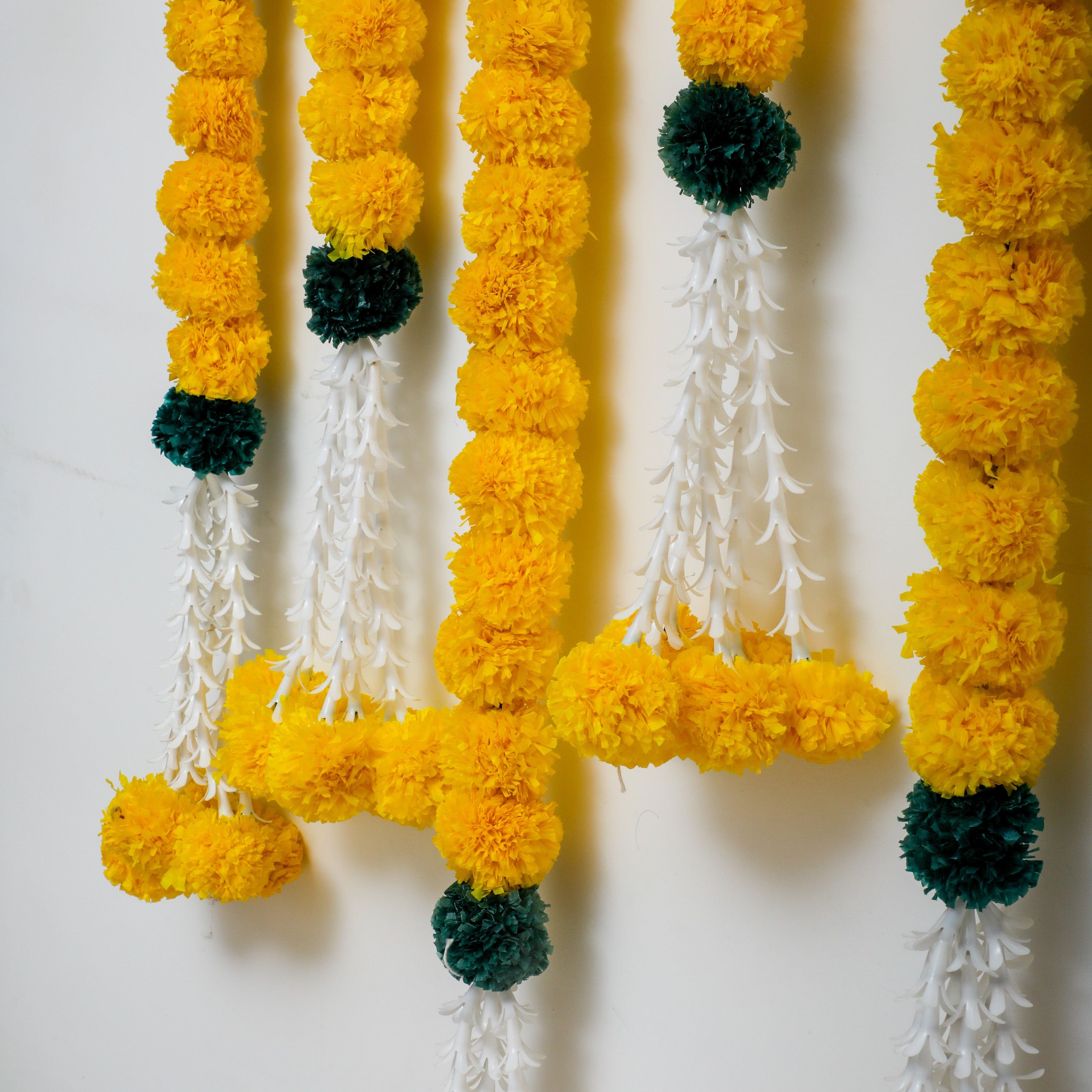 Made from artificial Marigold and Lily floral design