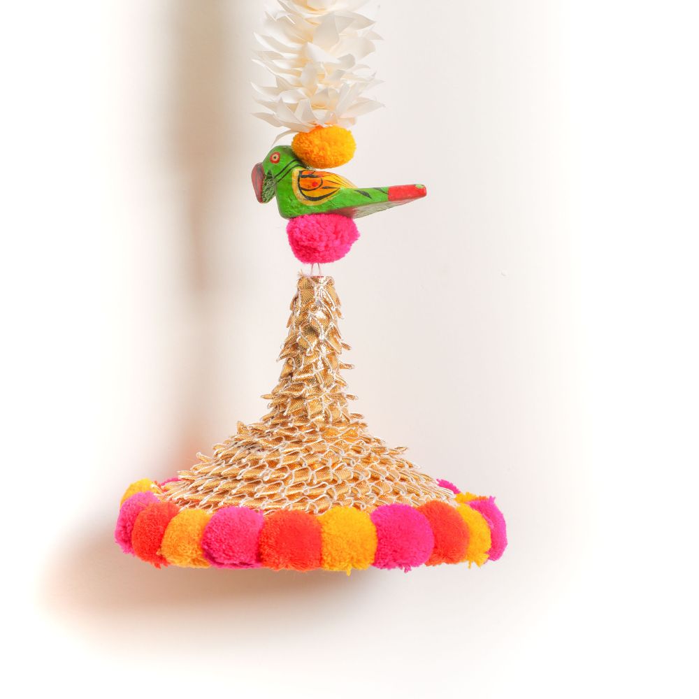 The garlands are adorned with beautifully crafted wooden parrots that add a unique touch to the overall design
